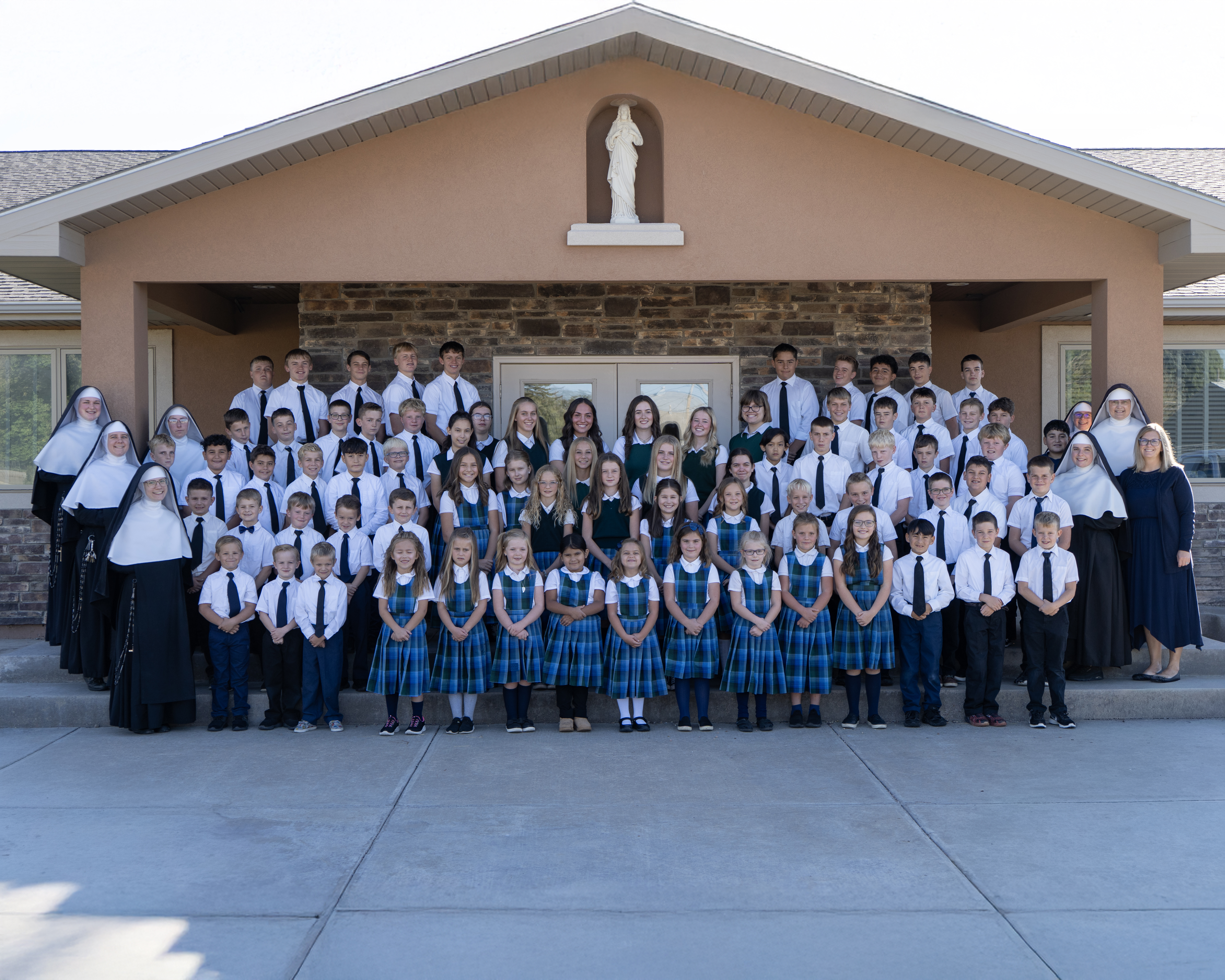 Sacred Heart Academy students and faculty gathered in front of the school building